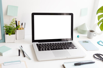 Fototapeta premium Laptop at trendy home office and books, papers, stationery around, Homeschooling concept. Creative desk. 