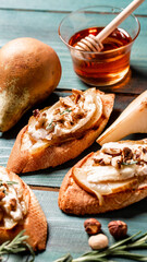 pears and brie camembert crostini. selective focus