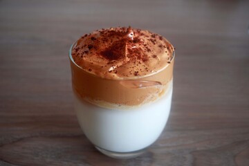 Close-up view of homemade dalgona coffee. Delicious whipped coffee on table. Amazing coffee for morning time.  