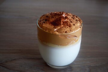 Close-up view of homemade dalgona coffee. Delicious whipped coffee on table. Coffee looks yummy