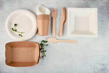 Biodegradable disposable tableware. Paper plates, cups, boxes. Wooden cutlery. Flat lay