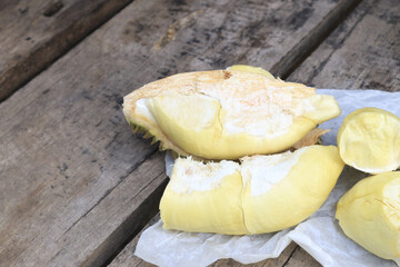 Durian riped and fresh with yellow colour on wooden table.