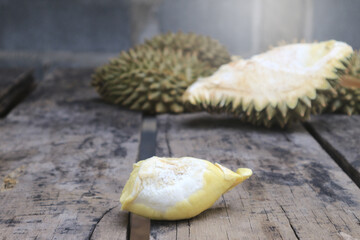 Durian riped and fresh with yellow colour on wooden table.