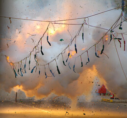 Explosions of firecrackers hanging on ropes in the fallas de valencia celebrating saint joseph's day