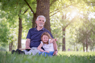 Grandfather and his granddaughter  playing  outdoors