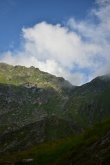 spring time at the mountains on sunny day with green grass in vibrant color