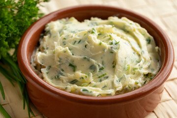 Bowl with herb butter close up