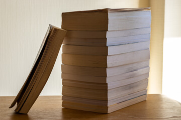 stack of old books on wooden table