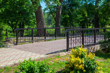 pedestrian bridge with pavement in the city park 