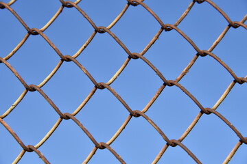 Fototapeta premium Metallic fence net against the sky