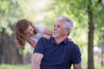 Grandfather and his granddaughter  playing  outdoors