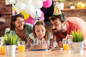 Family celebrating birthday together - Powered by Adobe