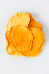 Mango chips on a white background. Dried and fresh mango on a white background.