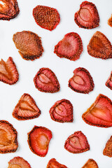 Strawberry Chips on a white background. Dried and fresh strawberries on a white background.
