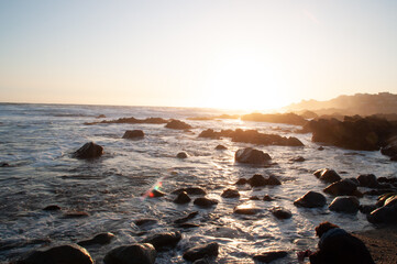 Stony beach on a sunny day with clouds