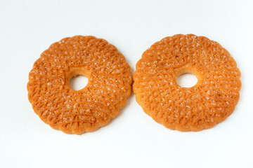Two round biscuits with sugar icing isolated on white background top view