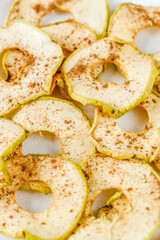 Chips from apples with cinnamon on a white background. Dried and fresh apples on a white background.