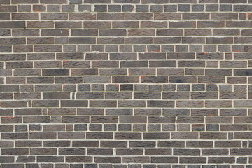 Fototapeta na wymiar Brown background of beautiful unusual building brick