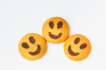 Three smiling biscuit cookies isolated on white background with copy space. Smile concept. Sweet greeting and friendship