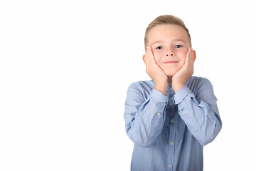 A surprised boy is holding his hands at his face; isolated on the white background