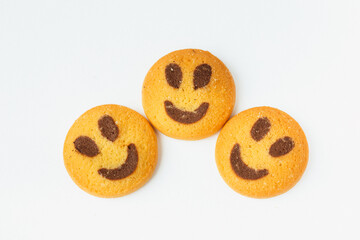 Three smiling biscuit cookies isolated on white background with copy space. Smile concept. Sweet greeting and friendship
