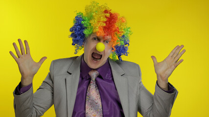 Clown businessman entrepreneur dancing, celebrate, making silly faces at work