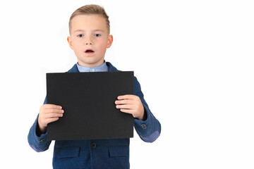 Happy exited caucasian young boy showing and displaying blank black board ready for your text or product.White background isolated.