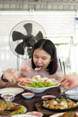 Woman eating food on dining table in restaurant