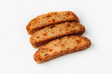 Three famous Italian Biscotti or Cantucci cookies stuffed with candied fruit isolated on white background.