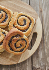 Tasty buns with raisins on a brown rustic wooden table. fresh bakery. breakfast. bread. top view