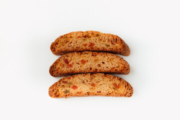 Three famous Italian Biscotti or Cantucci cookies stuffed with candied fruit isolated on white background.