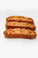 Three famous Italian Biscotti or Cantucci cookies stuffed with candied fruit isolated on white background.