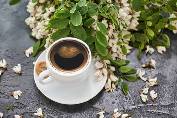 Cup of coffeel and acacia closeup. Nutrition. background with a cup of Coffee and acacia flowers.