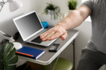 Fitness at home. Athletic man doing squats in his home office. Home workout.
