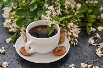 Cup of coffeel and acacia closeup. Nutrition. background with a cup of Coffee and acacia flowers.
