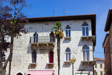 View of a classical colorful croatian house with some palmtrees at the foreground, in the old town...