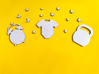 Children's yellow amber background with wooden figures indicating the date of birth, weight and height of the child. Metrics for postcards for the birth of a child. Copy the spaces for the text. 