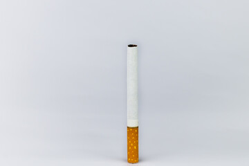 One cigarette Brown cigarette butts and white tips On a white background, vertical image