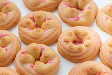 Cookie biscuit with pink  sugar cream icing  isolated on white background