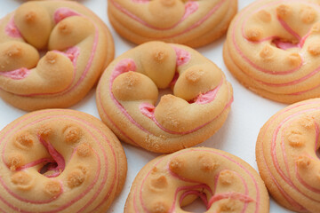 Cookie biscuit with pink  sugar cream icing  isolated on white background