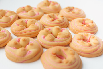 Cookie biscuit with pink  sugar cream icing  isolated on white background