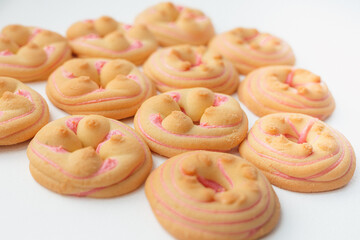 Cookie biscuit with pink  sugar cream icing  isolated on white background