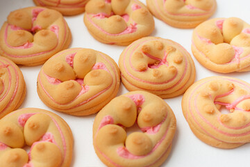 Cookie biscuit with pink  sugar cream icing  isolated on white background