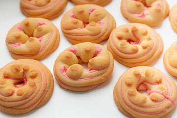 Cookie biscuit with pink  sugar cream icing  isolated on white background