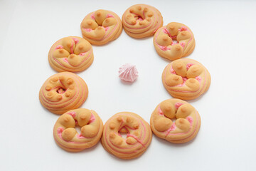 Cookie biscuit with pink  sugar cream icing  isolated on white background