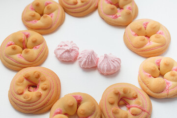 Cookie biscuit with pink  sugar cream icing  isolated on white background