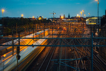 Two trains approaching downtown Helsinki railway station with the capital skyline on the horizon.