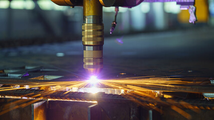 Plasma cut machine cutting steel sheet with sparks