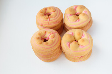 Cookie biscuit with pink  sugar cream icing  isolated on white background