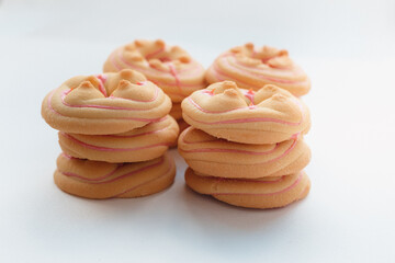Cookie biscuit with pink  sugar cream icing  isolated on white background